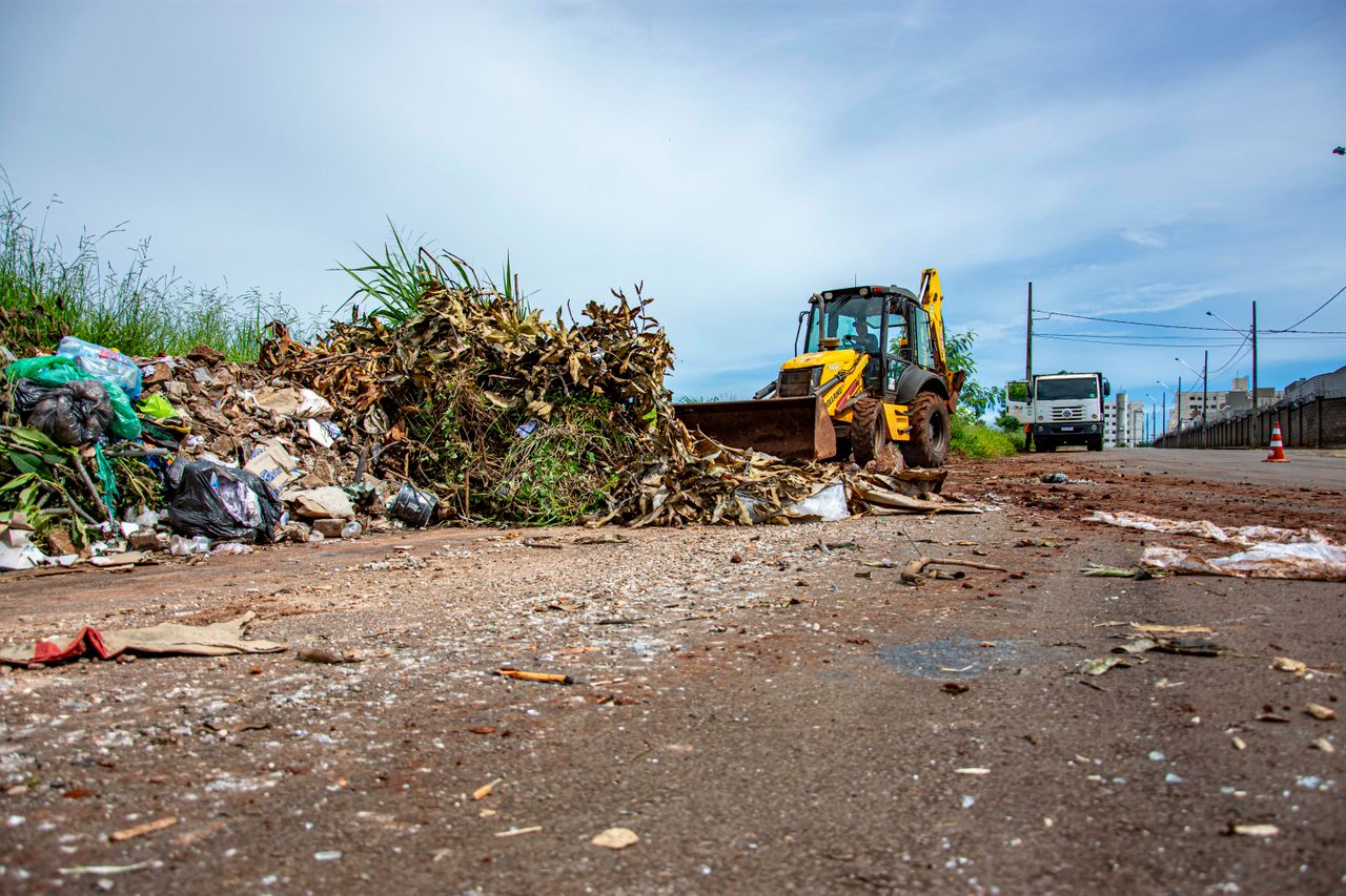Street cleaning operation with bulldozer and debris in Londrina, Brazil.