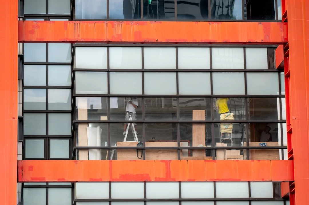 A man wearing a mask manages construction debris in a city environment from a large truck.