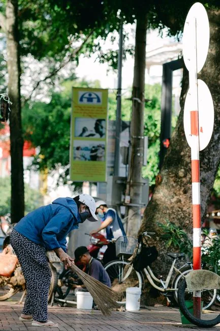 Volunteers work together to clean up debris after a natural disaster, showcasing community effort and teamwork.